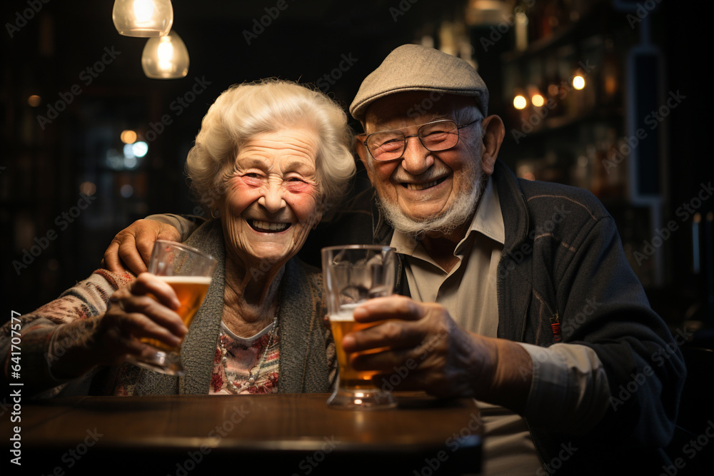 Active social lifestyle of senior people concept. Mature couple having fun drinking beer at cafe bar restaurant. Husband and wife hanging out enjoying happy hour at brewery pub. 