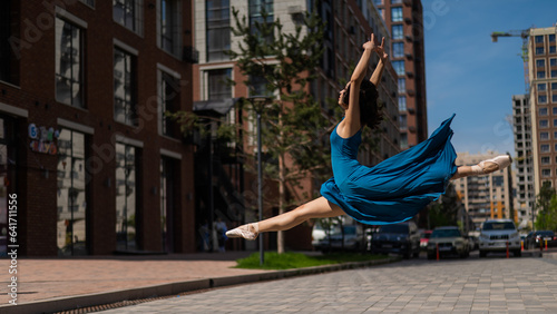 Fotografie Beautiful Asian ballerina dancing outdoors