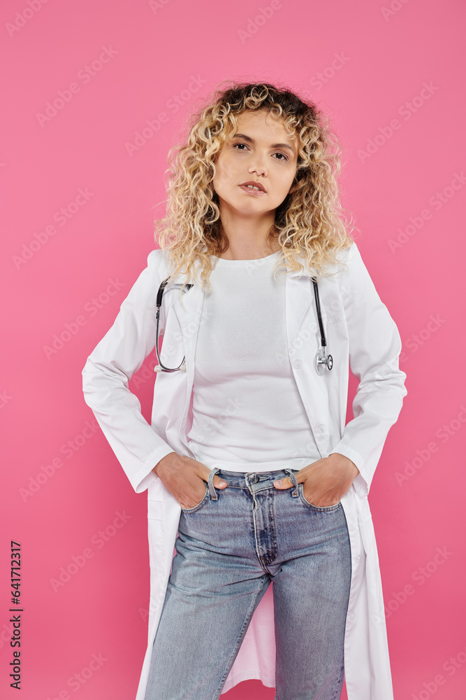 breast cancer awareness concept, curly female doctor looking at camera, pink backdrop, happy woman breast cancer awareness concept, curly female doctor looking at camera, pink backdrop, happy woman