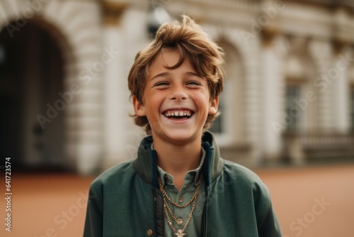 Fotografie, Obraz Medium shot portrait photography of a happy kid male laughing showing off a delicate necklace at the buckingham palace in london england