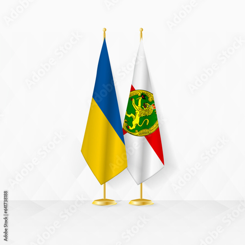 Ukraine and Alderney flags on flag stand, illustration for diplomacy and other meeting between Ukraine and Alderney.