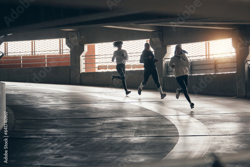 Women jogging through a parking garage photo