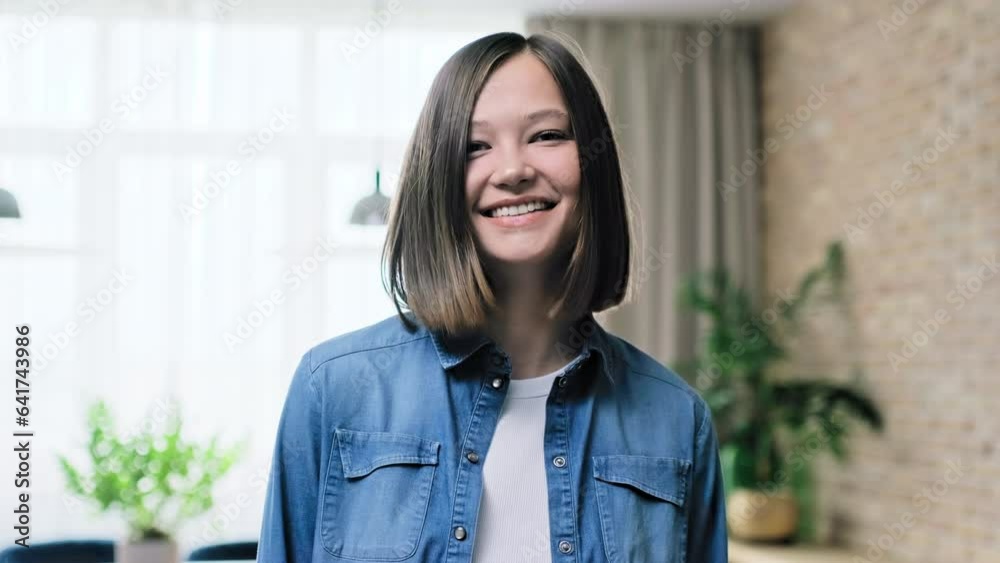 Headshot portrait of beautiful young smiling woman, in home interior Headshot portrait of beautiful young smiling woman, in home interior
