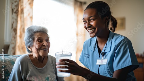 Fotografering A smiling nurse offering a cup of water to a recovering patient, symbolizing the