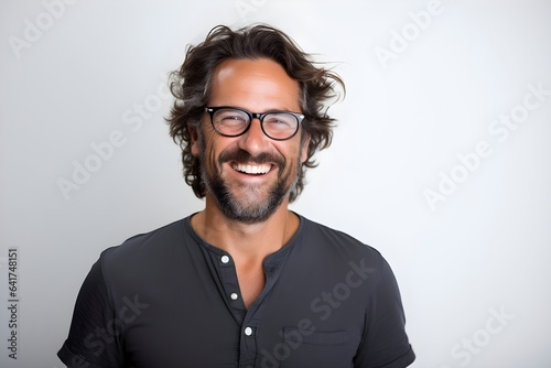 a man with glasses and a beard smiles
