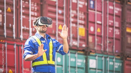 Engineer or technician wear VR (Virtual Reality) glasses and moves his hand like touching some icon in vr screen, with shipping freight cargo container dock in background. Logistic management concept.