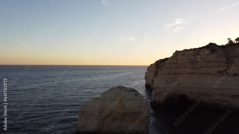 Left Pan Rocks and Water Drone View Looking out at the Ocean. Skyline, ocean, and rocky cliffs. Shoreline of Portugal. Left Pan Rocks and Water Drone View Looking out at the Ocean. Skyline, ocean, and rocky cliffs. Shoreline of Portugal.