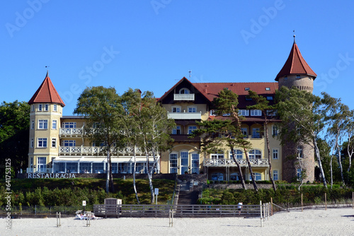 A view of historic hotel building on sand dune, Leba beach, Baltic Sea, Poland. Castle on the beach. Beautiful sunny weather photo