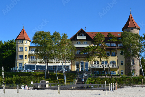 A view of historic hotel building on sand dune, Leba beach, Baltic Sea, Poland. Castle on the beach. Beautiful sunny weather
