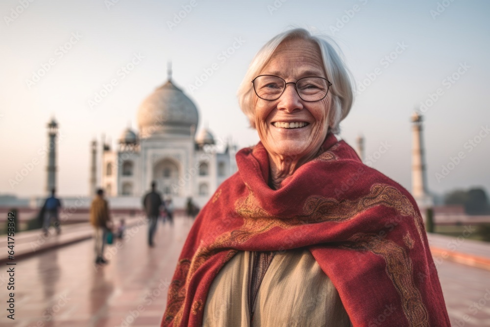 Lifestyle portrait photography of a happy mature woman wearing a cozy sweater in front of the taj mahal in agra india. With generative AI technology