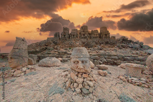 The ancient carved heads of Zeus, Apollo, Hercules and lion at sunset on the east terrace at Mount Nemrut (Nemrut Dağı) an archaeological site of the ancient Kingdom of Commagene in south east Turkey photo