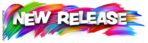 New release paper word sign with colorful spectrum paint brush strokes over white.