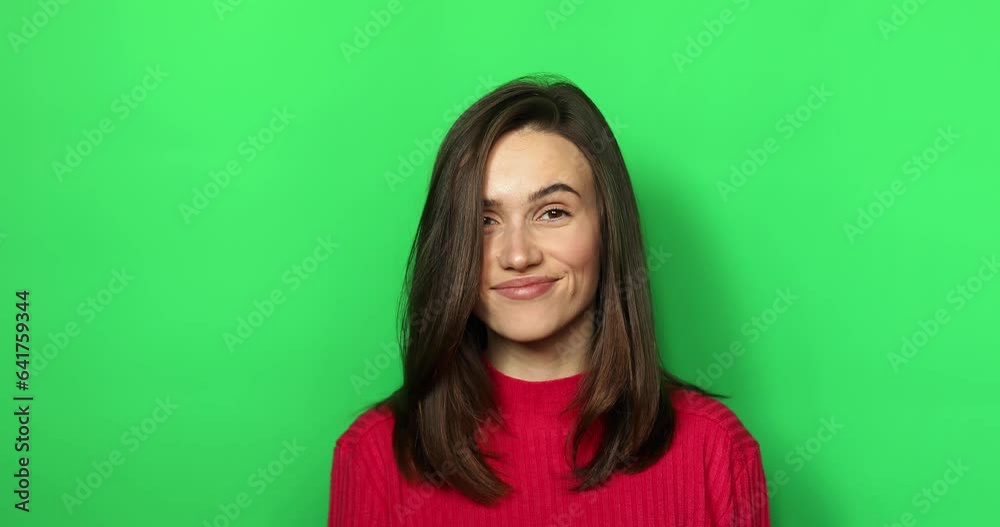 Playful female demonstrate gesture quite showing forefinger on green studio background. Smiling woman having secrecy saying hush or shh with finger on lips. Concept of gossip, secret. Playful female demonstrate gesture quite showing forefinger on green studio background. Smiling woman having secrecy saying hush or shh with finger on lips. Concept of gossip, secret.