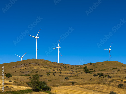 Aerial view of wind turbines and agriculture field
