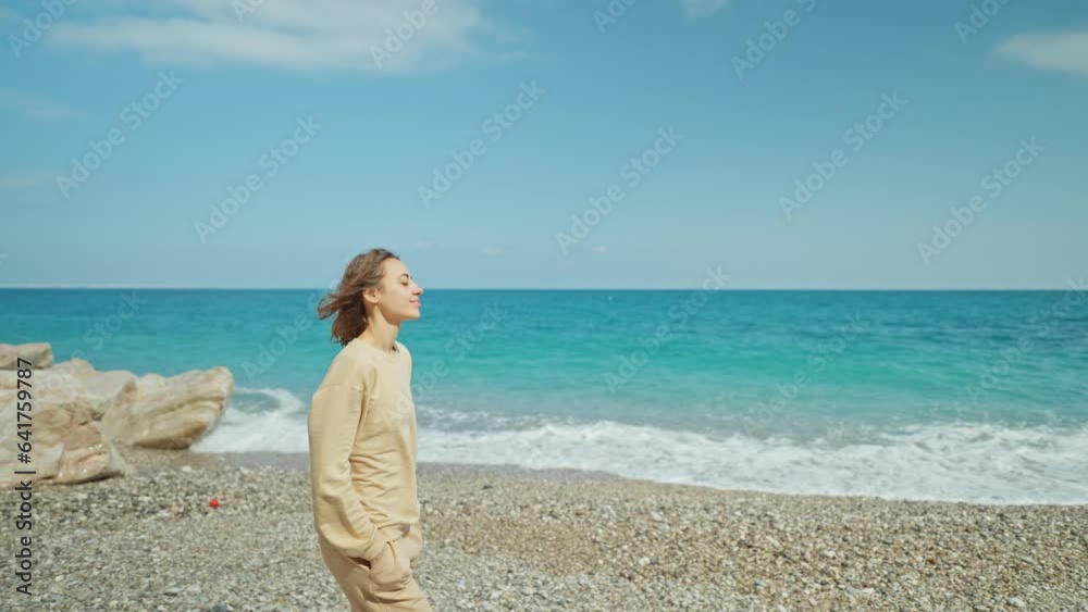 Outdoor portrait beautiful summer woman walking pebble beach and enjoying weekend at seaside with cliffs by the sea coast. Outdoor portrait beautiful summer woman walking pebble beach and enjoying weekend at seaside with cliffs by the sea coast.