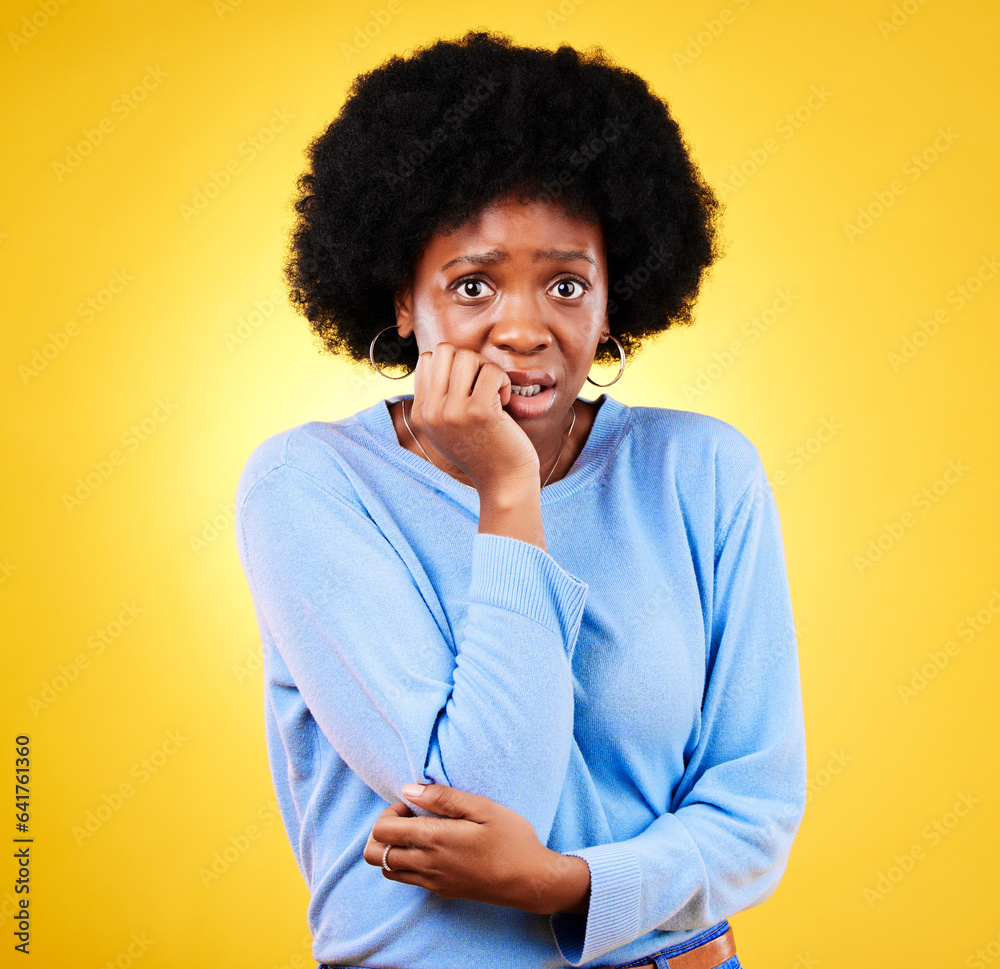 Biting nails, anxiety and a scared woman in studio for fear, mental health or nervous behaviour. Portrait of African person on yellow background worried, stress or panic for phobia, terror or horror Biting nails, anxiety and a scared woman in studio for fear, mental health or nervous behaviour. Portrait of African person on yellow background worried, stress or panic for phobia, terror or horror