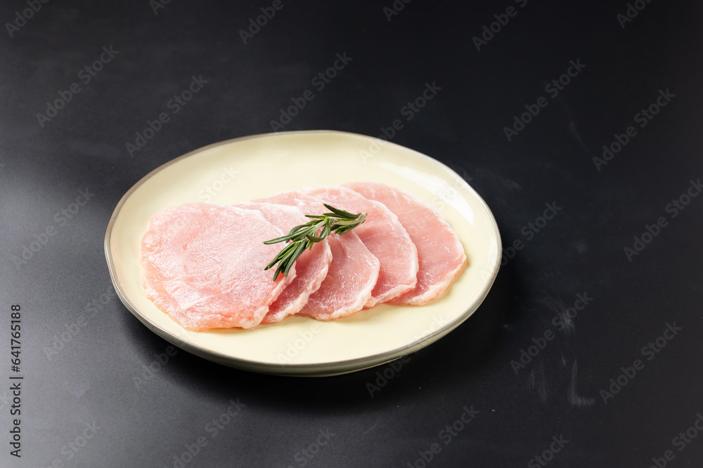 Fresh raw sliced pork belly. Sliced pork neck and pork belly. Japanese and korean rare beef for grilled on black plate food isolated on black banner background Fresh raw sliced pork belly. Sliced pork neck and pork belly. Japanese and korean rare beef for grilled on black plate food isolated on black banner background
