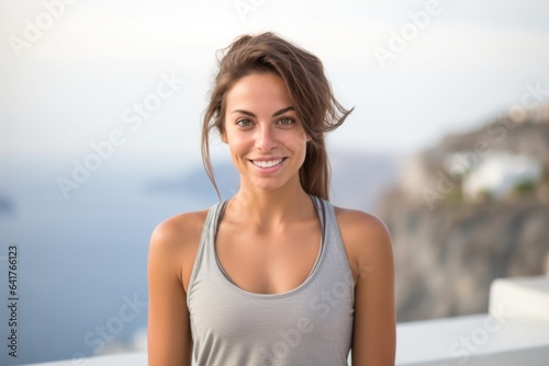 Headshot portrait photography of a blissful girl in his 30s wearing a comfortable yoga top at the santorini island greece. With generative AI technology