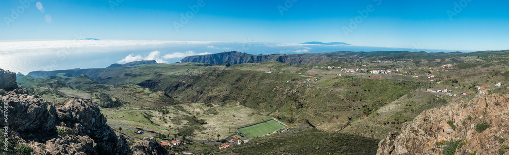 Fototapeta premium Panoramic view from peak of Alto de at Garajonay mountain with l forest and hills, Garajonay National Park, La Palma island and small villages. La Gomera, Canary Islands, Spain.