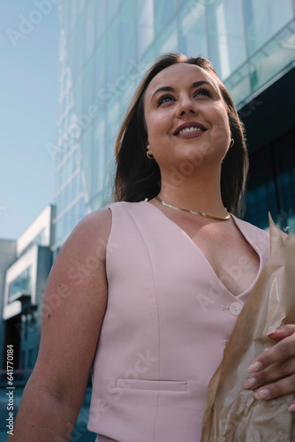 Confident Stride: Happy Model in Light Pink Dress & Round Sunglasses in City photo