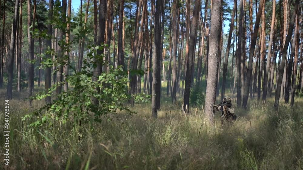 Ukraine, Warzone, August 29, 2023: Ukrainian soldiers advance during the war. Soldier in the forest with a weapon. War of Russia against Ukraine Ukraine, Warzone, August 29, 2023: Ukrainian soldiers advance during the war. Soldier in the forest with a weapon. War of Russia against Ukraine