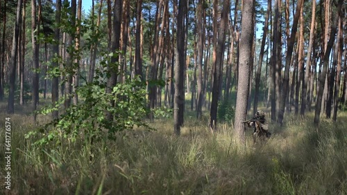 Ukraine, Warzone, August 29, 2023: Ukrainian soldiers advance during the war. Soldier in the forest with a weapon. War of Russia against Ukraine
