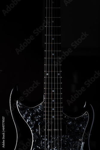 Vertical photo pf a guitar, isolated on black background