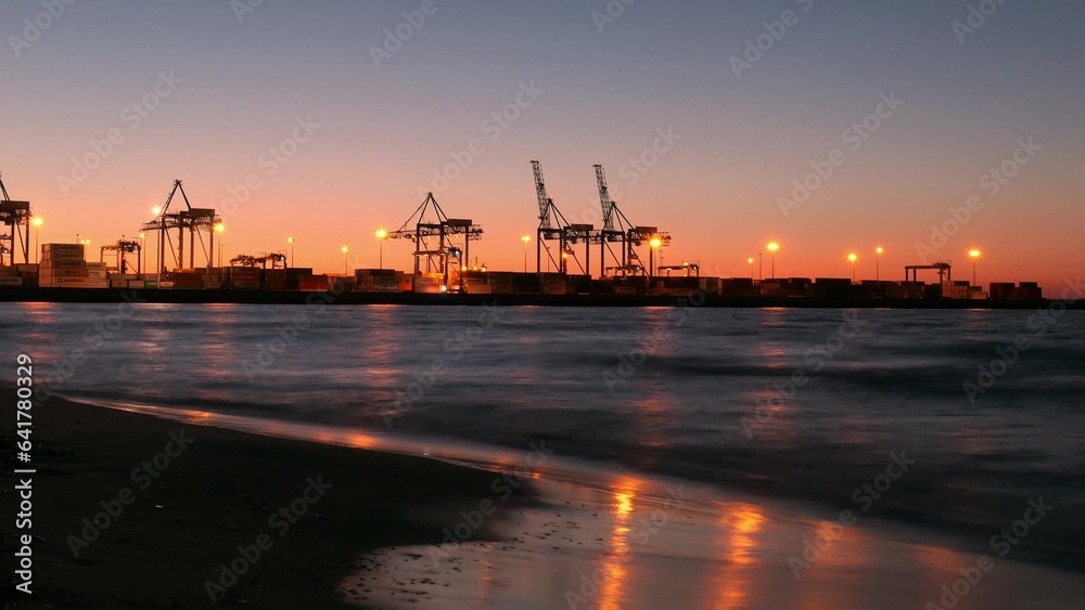 Time Lapse Container Ship Terminal and Cranes in the Evening