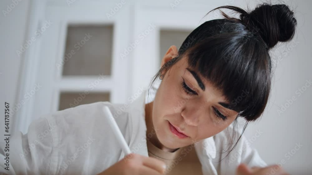 Graphic designer drawing pen in house close up. Focused woman sketching tablet Graphic designer drawing pen in house close up. Focused woman sketching tablet