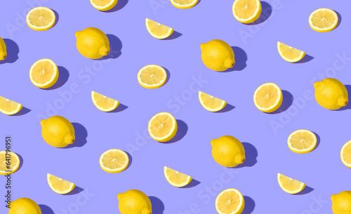 Colorful pattern of fresh ripe whole and sliced lemons