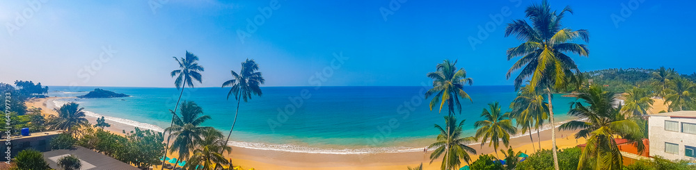 Beautiful paradise tropical beach waves palms Mirissa Beach Sri Lanka.