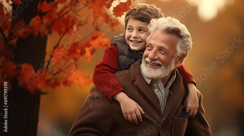 Happy grandpa and grandson on beautiful autumn park, family bonding moment with copy space. © JW Studio