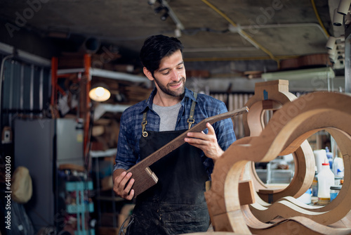 Luthier is working on the neck of a classical guitar