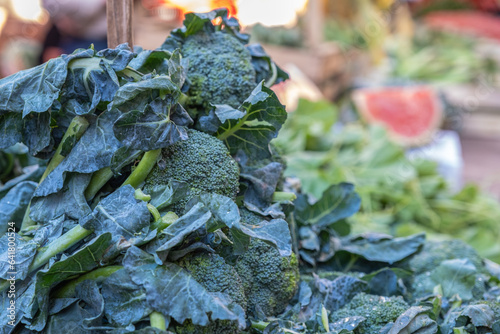 Broccoli Rabe on a street food market, in Palermo Sicily, vegetable stand with blurred background photo