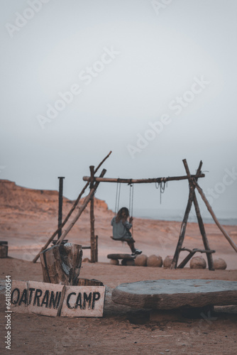 Woman on a swing in the Desert Landscape, Fayoum Oasis, Egypt