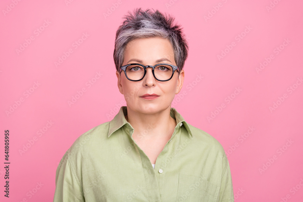 Portrait of focused intelligent corporate ceo lady calm concentrated face wear green shirt isolated on pink color background