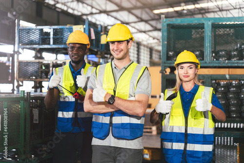 Group of Diverse Warehouse Workers Standing With Thumbs Up Showing Success Work in Factory, Industrial Management and Teamwork for Optimal Efficiency.