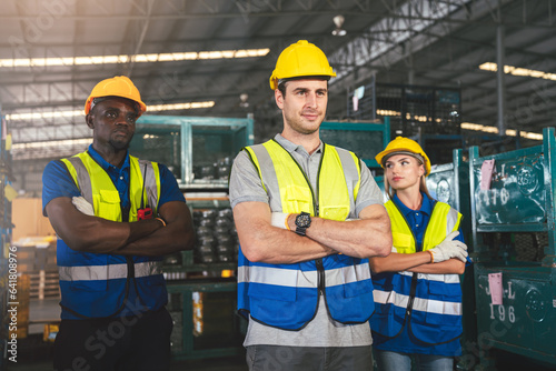 Group of Multiethnic Warehouse Workers Standing With Arms Crossed Together With Colleague in Factory, Industrial Management and Teamwork for Optimal Efficiency.
