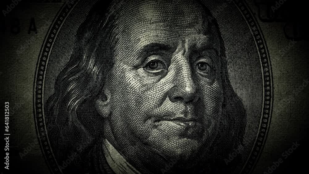 The portrait of Benjamin Franklin on the 100 US dollar bill is a close-up that gradually darkens and the eyes begin to glow. The idea of a conspiracy theory. 4k concept video.