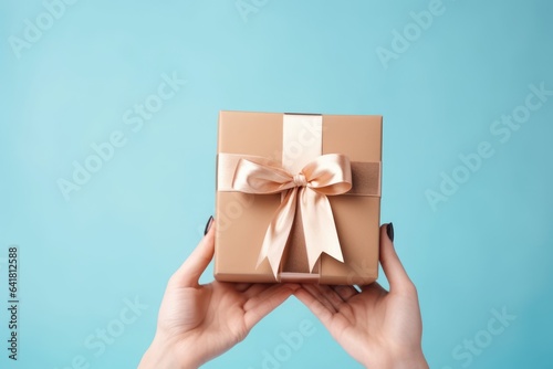 a woman holds a gift box with cosmetics on a blue background