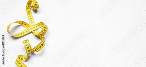 Measuring tape on white background with space for text, top view photo