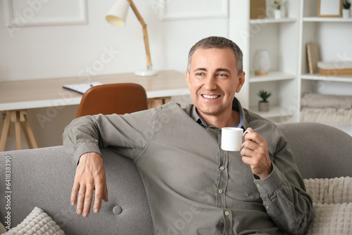 Happy mature man with cup o...