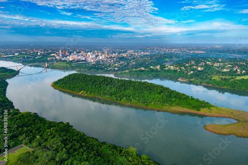 Aerial view of the Paraguayan city of Ciudad del Este and Friendship Bridge, connecting Paraguay and Brazil through the border over the Parana River. photo