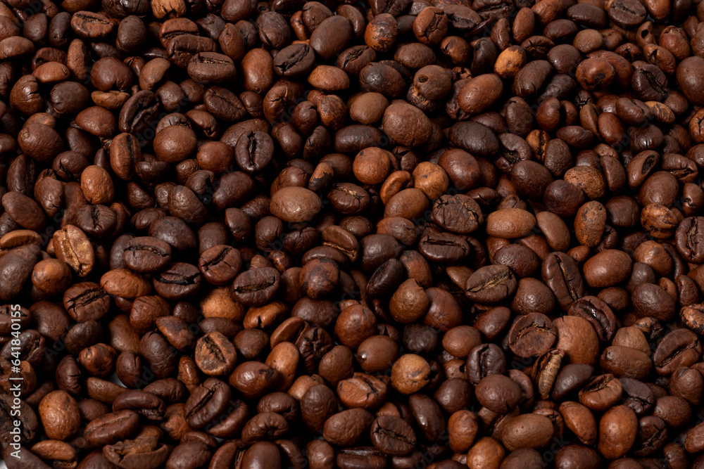 whole roasted coffee beans in close-up as a background image whole roasted coffee beans in close-up as a background image