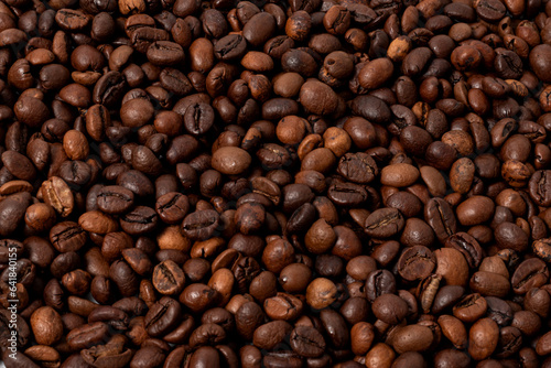 whole roasted coffee beans in close-up as a background image