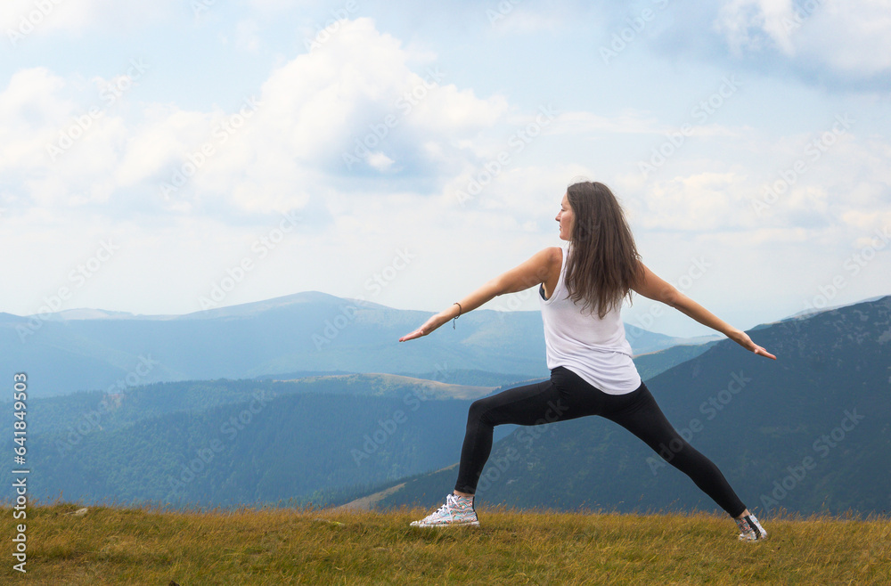 A young woman practices meditation in nature. Concentration position, yoga.
