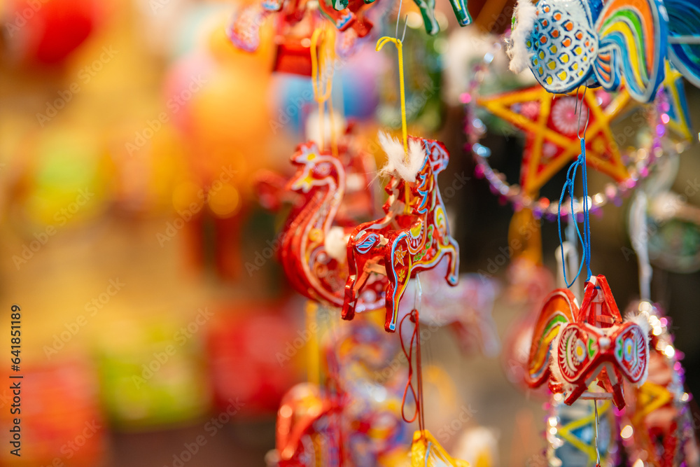 Decorated colorful lanterns hanging on a stand in the streets in Ho Chi ...