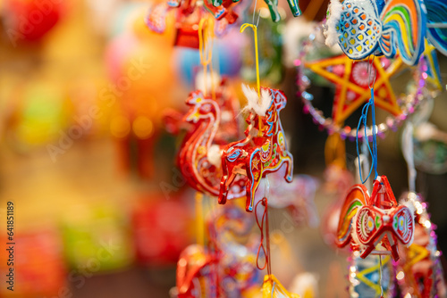 Decorated colorful lanterns hanging on a stand in the streets in Ho Chi Minh City  Vietnam during Mid Autumn Festival. Chinese language in photos mean money and happiness