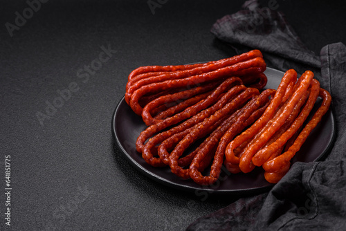 Delicious thin smoked hunting sausages with salt, spices and herbs