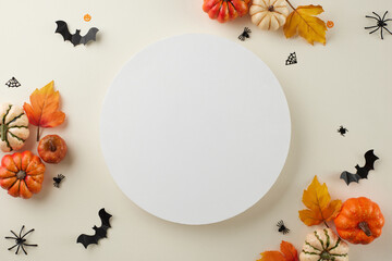 Captivating the spectral essence of the Halloween spirit. Top view shot of colorful pumpkins, autumn leaves, halloween decor on light grey background with blank space for ads or text